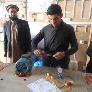 Student doing practical work and teacher is present to help